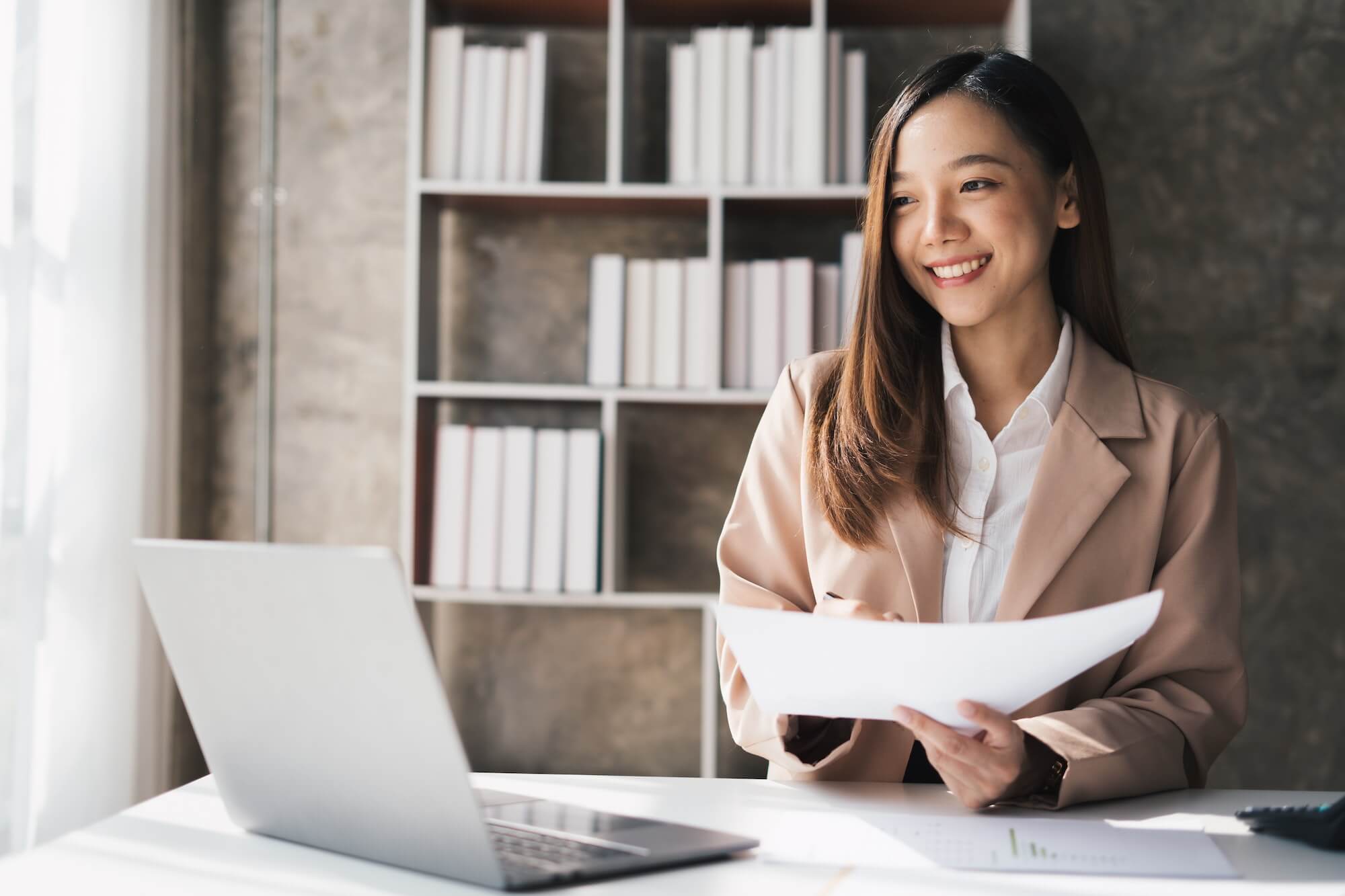Young Happy Businesswoman Using Computer in Modern Office with Colleagues. Stylish Beautiful Manager